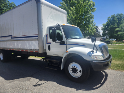 Box truck 2020 International MV607 side view showing cab and large cargo box.
