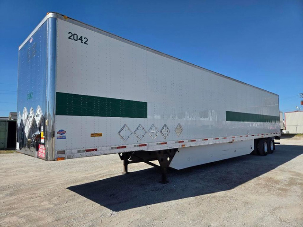 Utility van trailer showing side panel with reflective green stripes and front loading area, with wheel axles and landing gear visible.