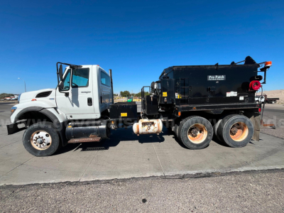 Truck side view of 2011 International WorkStar 7600 asphalt hot oil truck with Pro-Patch body and black tank; visible VIN tag and stock number in listing.