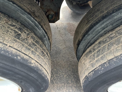 Rear view of a 2018 Utility 3000R trailer showing dual axles with worn tires and dirt on rims.