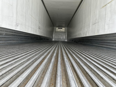 Trailer interior showing ribbed metal floor and side walls of a 2018 Utility 3000R reefer trailer, long empty cargo area.