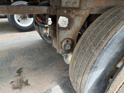 Trailer wheel assembly and rusty chassis frame with tire showing undercarriage of a 2018 Utility 3000R reefer trailer.
