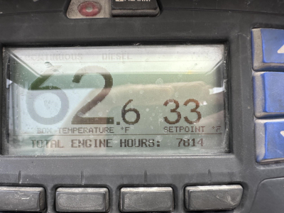 Engine control display showing numbers 62.6 33 and TOTAL ENGINE HOURS 7814 on a diesel engine gauge.