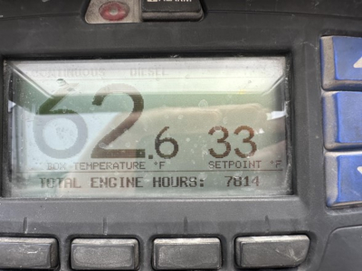 Truck trailer digital display showing engine hours and temperatures: 62.6 box temperature? 33 setpoint? total engine hours 7814. Fine print unreadable labels around. 