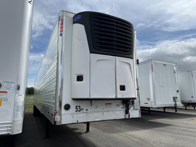 Utility 3000R refrigerated trailer front corner with vertical unit and black grille, white body, red ‘3000R’ decal, and trailer legs visible.
