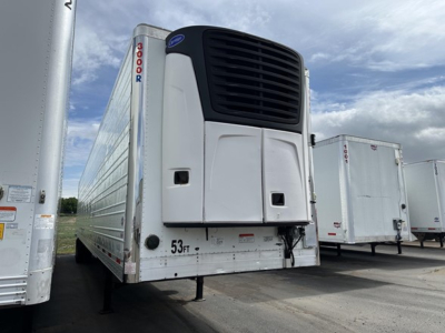 Utility reefer trailer with Thermo King unit on front, white exterior, vertical '3000R' branding near nose, 53,000 lb capacity markings, other trailers in background.