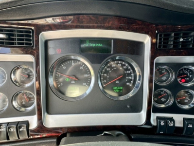 Kenworth W900L dashboard showing gauges and digital trip info display