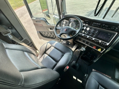 Kenworth W900L interior cab showing steering wheel dashboard gear shifter and seats