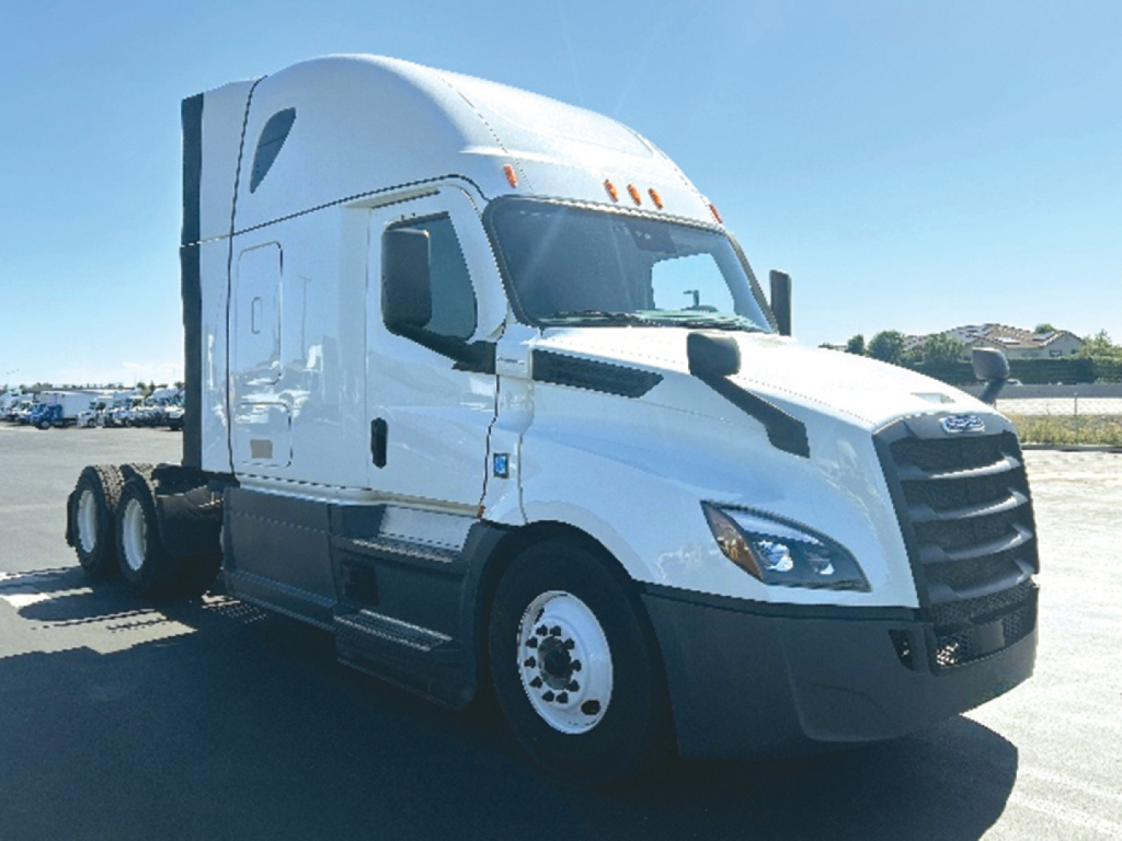 Truck side view of a white 2023 Freightliner Cascadia126 tractor with sleeper cab.