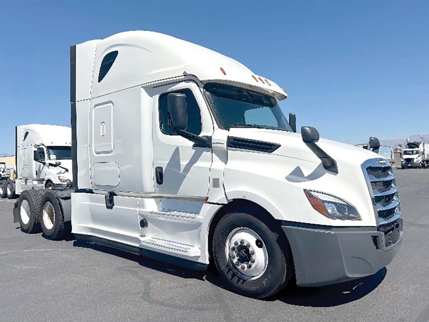 Freightliner Cascadia126 truck cab side view showing white exterior and sleeper cab.