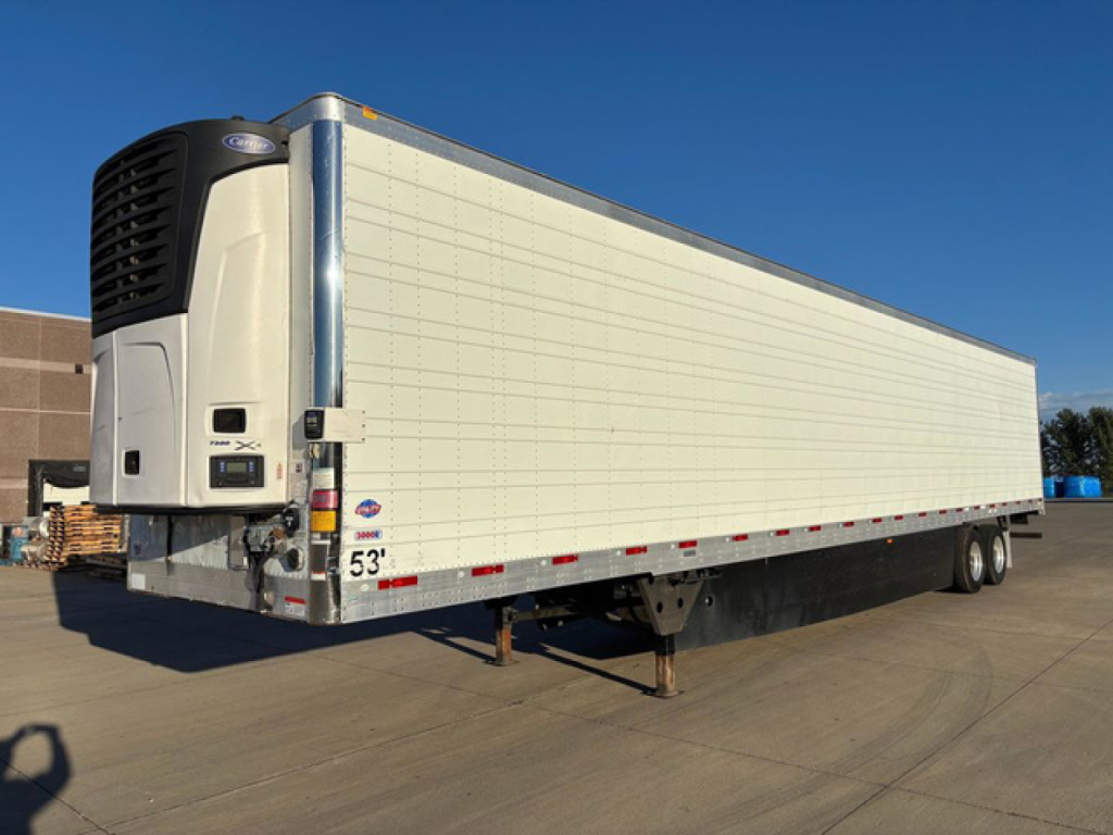 Trailer side view showing a white refrigerated trailer with a large front refrigeration unit and vertical doors; stock tag 53" rear; brand label near front; wheelset and landing gear visible.