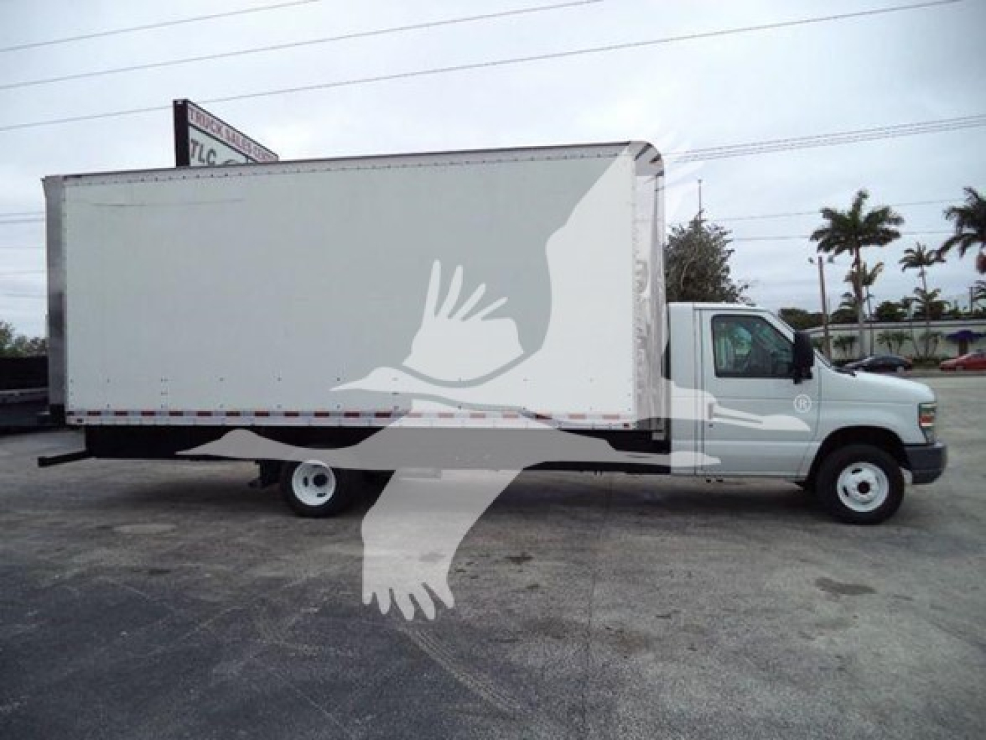Box truck 2011 Ford E450 side view with large cargo box and dual rear wheels showing stock number T17033 and VIN 1FDXE4FS7BDB17033.