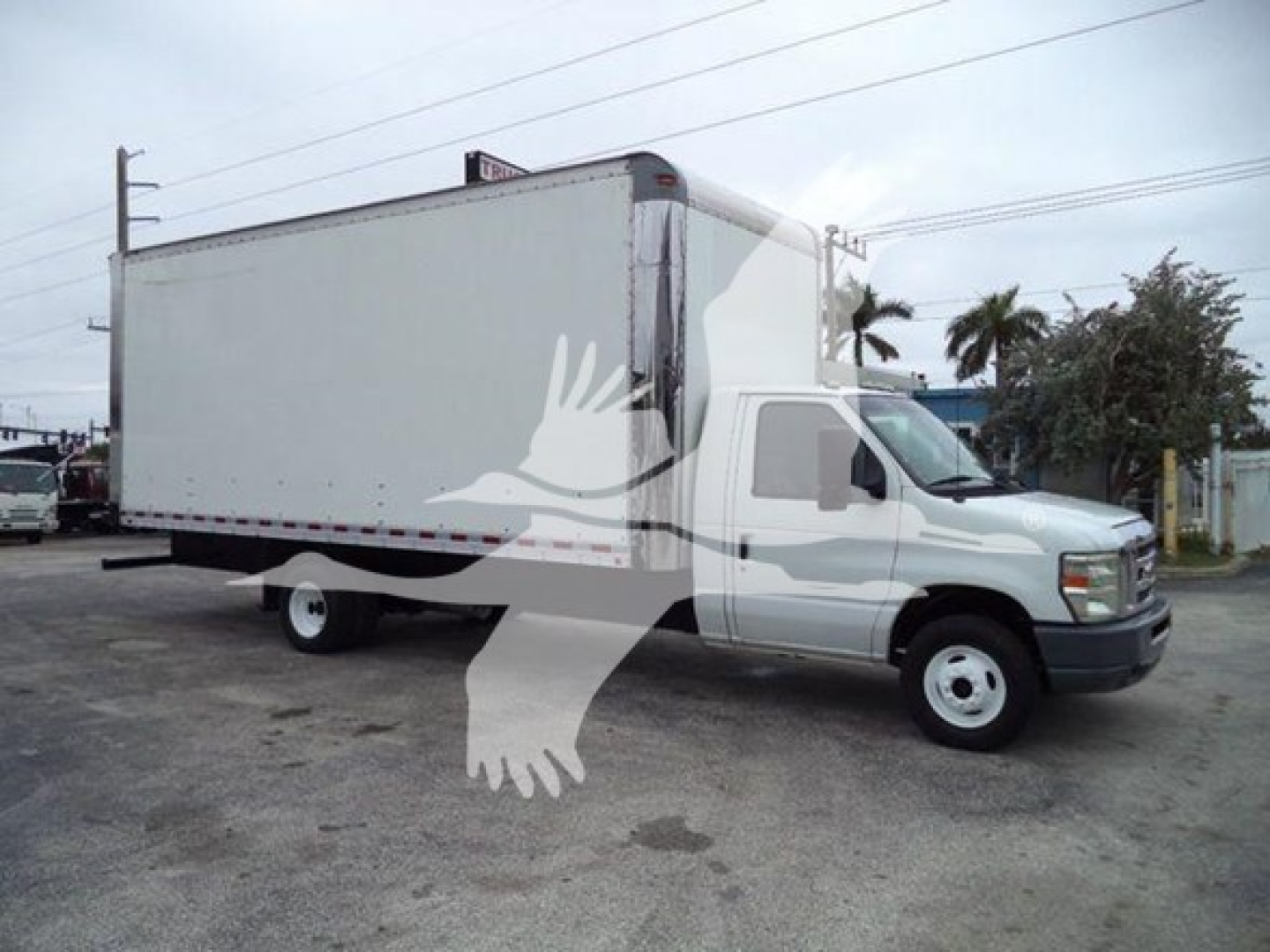 2011 Ford E450 box truck with a large cargo box and white cab, side view showing the vehicle.
