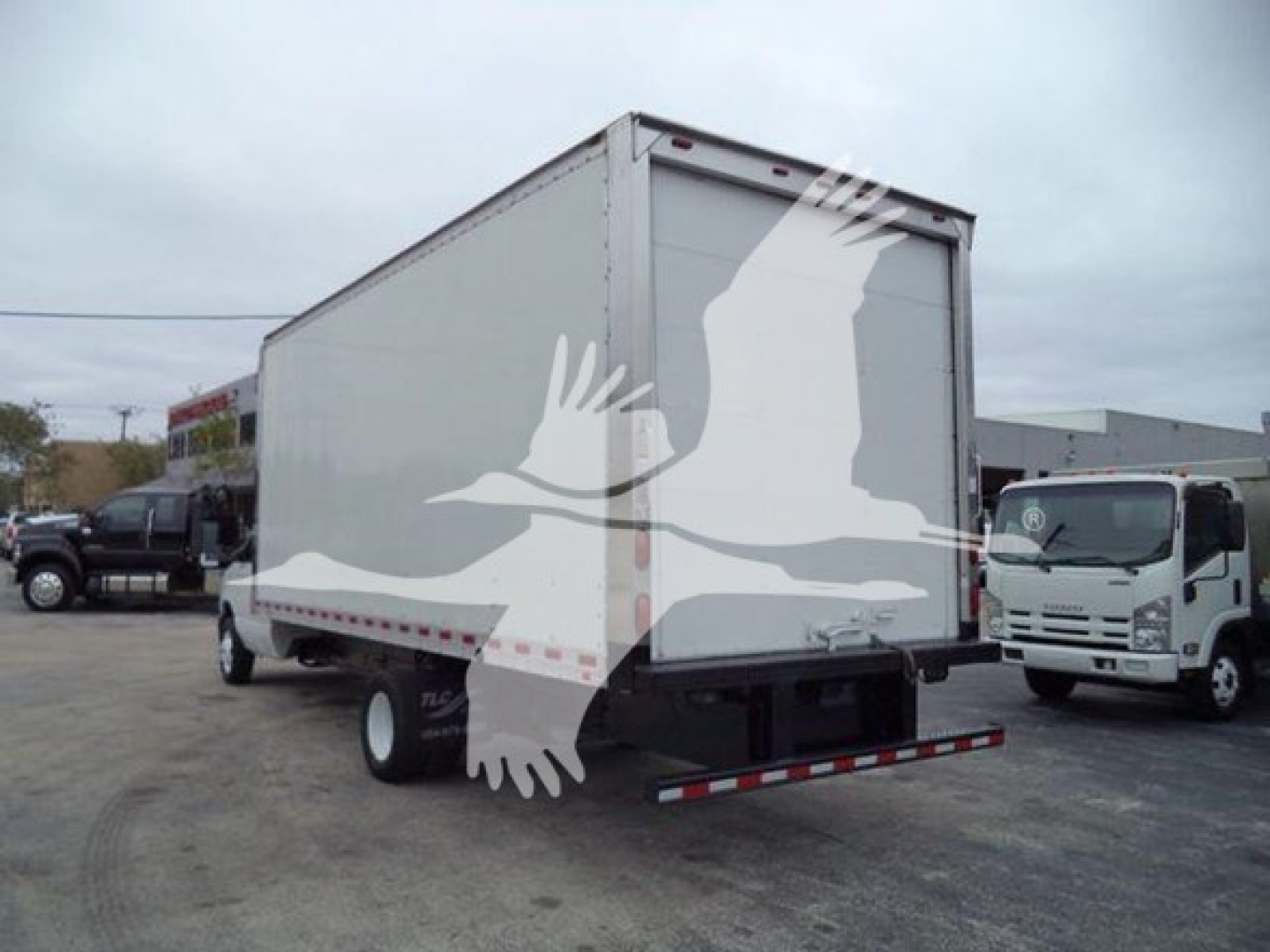Ford E-Series box truck rear view showing cargo area and rear bumper with reflective striping.