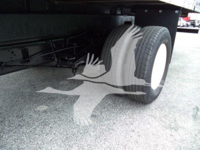 Rear wheel and undercarriage of a 2011 Ford E450 box truck showing dual rear tires and chassis components.