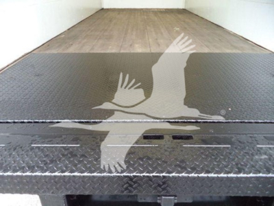 Ford E-450 box truck interior showing metal floor with diamond plate tread and loading ramp area.