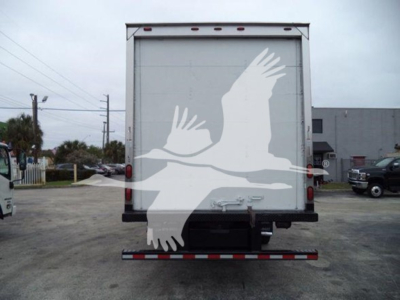 Ford E-450 box truck rear showing cargo doors and reflective bumper.
