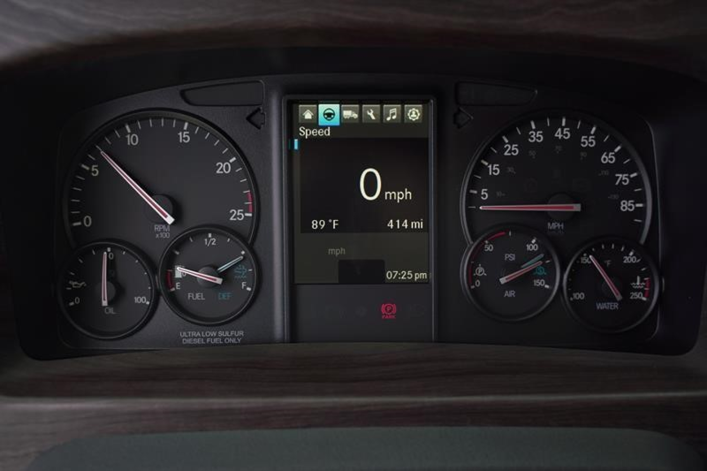 Dashboard of a Western Star 47X showing digital speed display at 0 mph, outside temp 89°F, range 414 miles, time 07:25 PM, and analog gauges for speed, fuel, oil, and temperature.