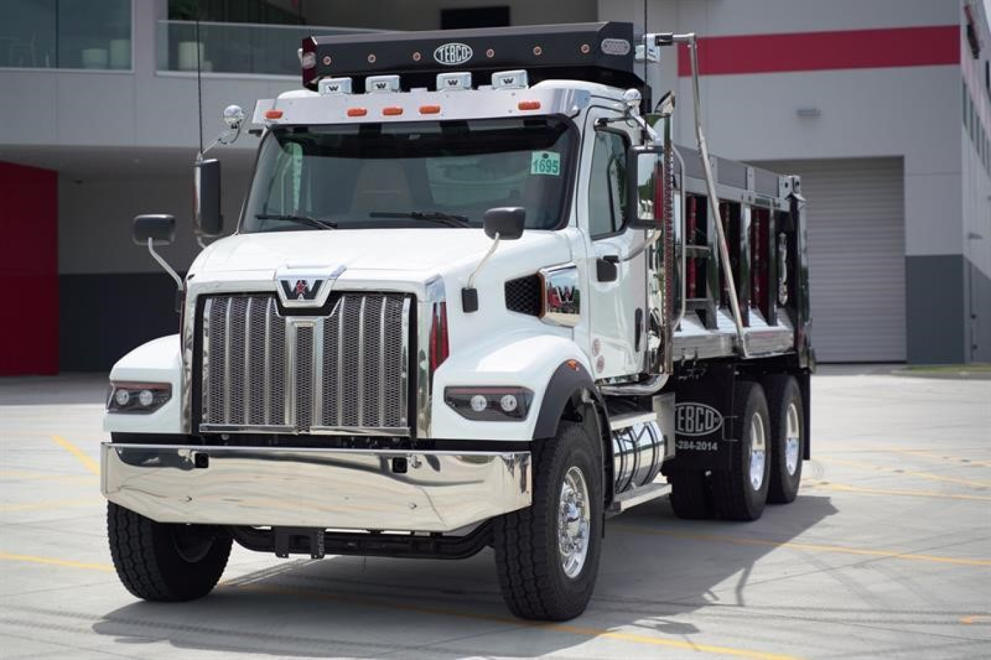 White Western Star 47X dump truck front view showing chrome grille and dual headlights.