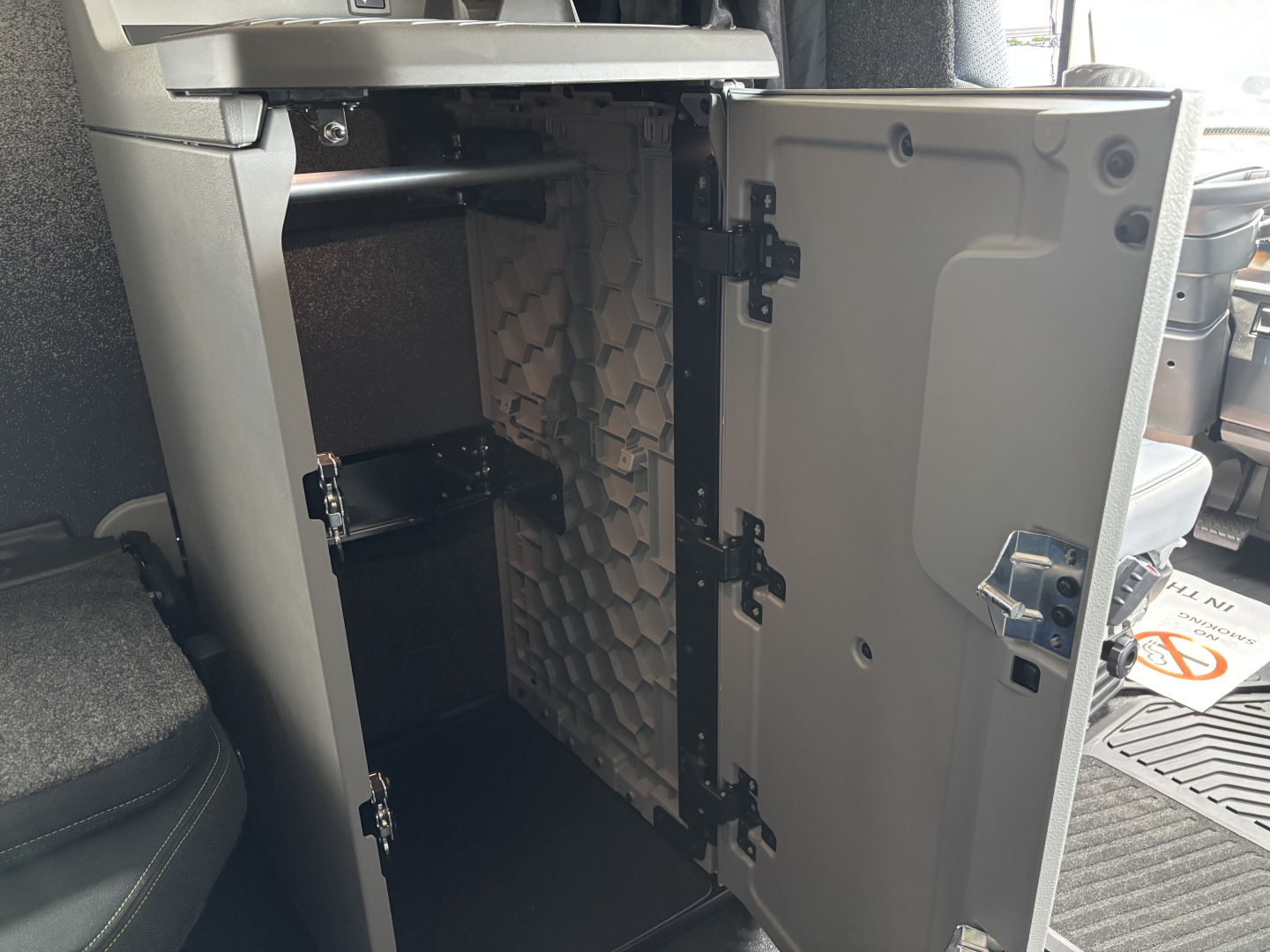 Volvo VNL64T860 cab interior showing open storage drawer with ribbed partition and near-empty compartment.