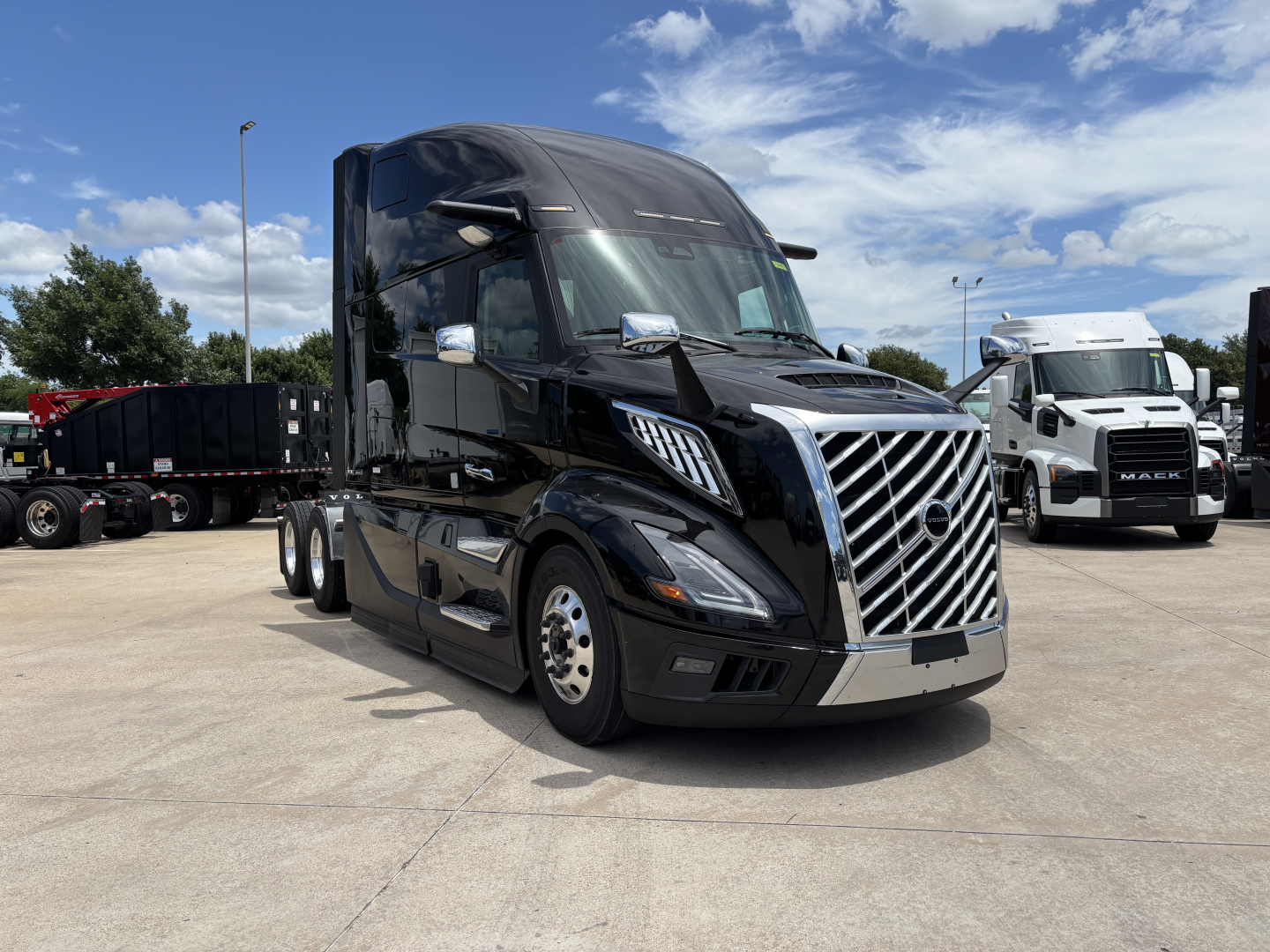 Conventional sleeper 2027 Volvo VNL64T860 tractor shown from front-left, black exterior, chrome grille, daytime running lights, aerodynamic mirrors, large sleeper cab.