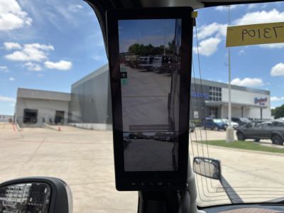 Volvo VNL truck dashboard tablet display mounted in cab showing exterior lot view.