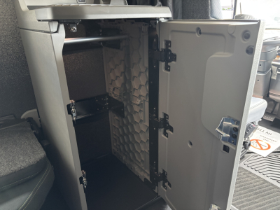Volvo VNL64T860 cab interior showing open storage drawer with ribbed partition and near-empty compartment.