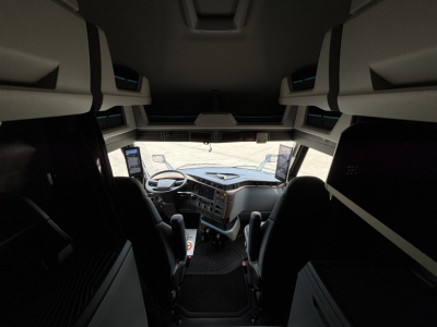  Volvo VNL cabin interior view from back of sleeper showing dashboard and overhead bunk storage panels.