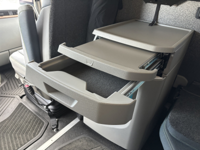Volvo VNL64T860 interior cab showing three open drawers and storage system.