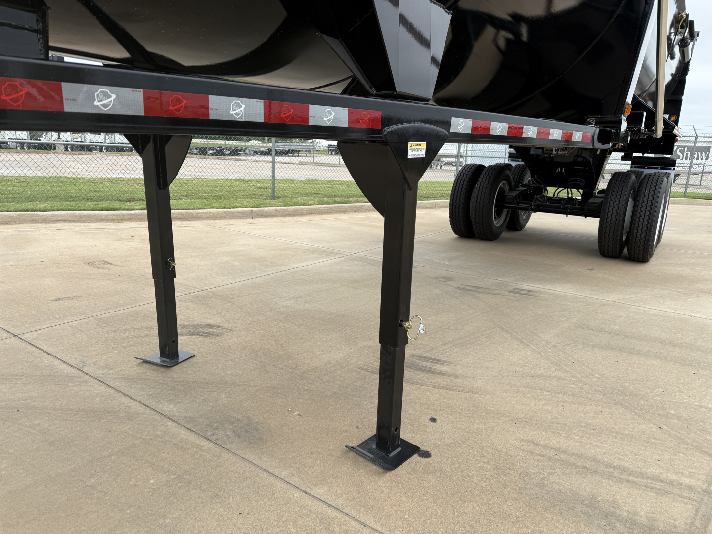 Armor Lite SHD32/48 trailer landing gear and undercarriage showing support legs and reflective tape on side rail.