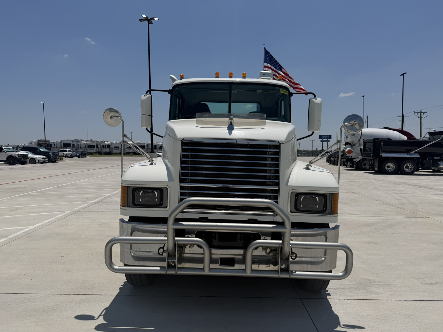 Front view of a white 2020 Mack PI64T conventional daycab truck showing grille, bumper guard, and headlights.