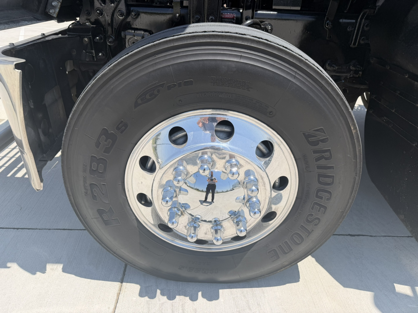 Mack PI64T wheel and Bridgestone tire close-up showing chrome wheel with center cap and lug nuts