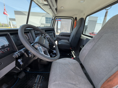 Cab interior of a 2020 Mack PI64T conventional daycab showing steering wheel, dashboard, and two front seats.