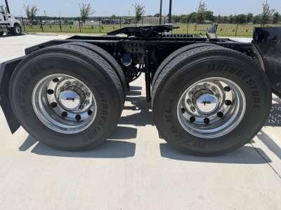 Dual rear wheels of a 2020 Mack PI64T truck showing tires and chrome wheels with hubcaps.