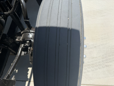 Seat and frame area of a 2020 Mack PI64T truck showing seat with ribbed pattern and surrounding chassis components.