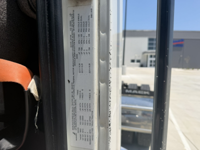 Mack PI64T cab interior door area showing door jamb sticker with vehicle specs and VIN sticker.
