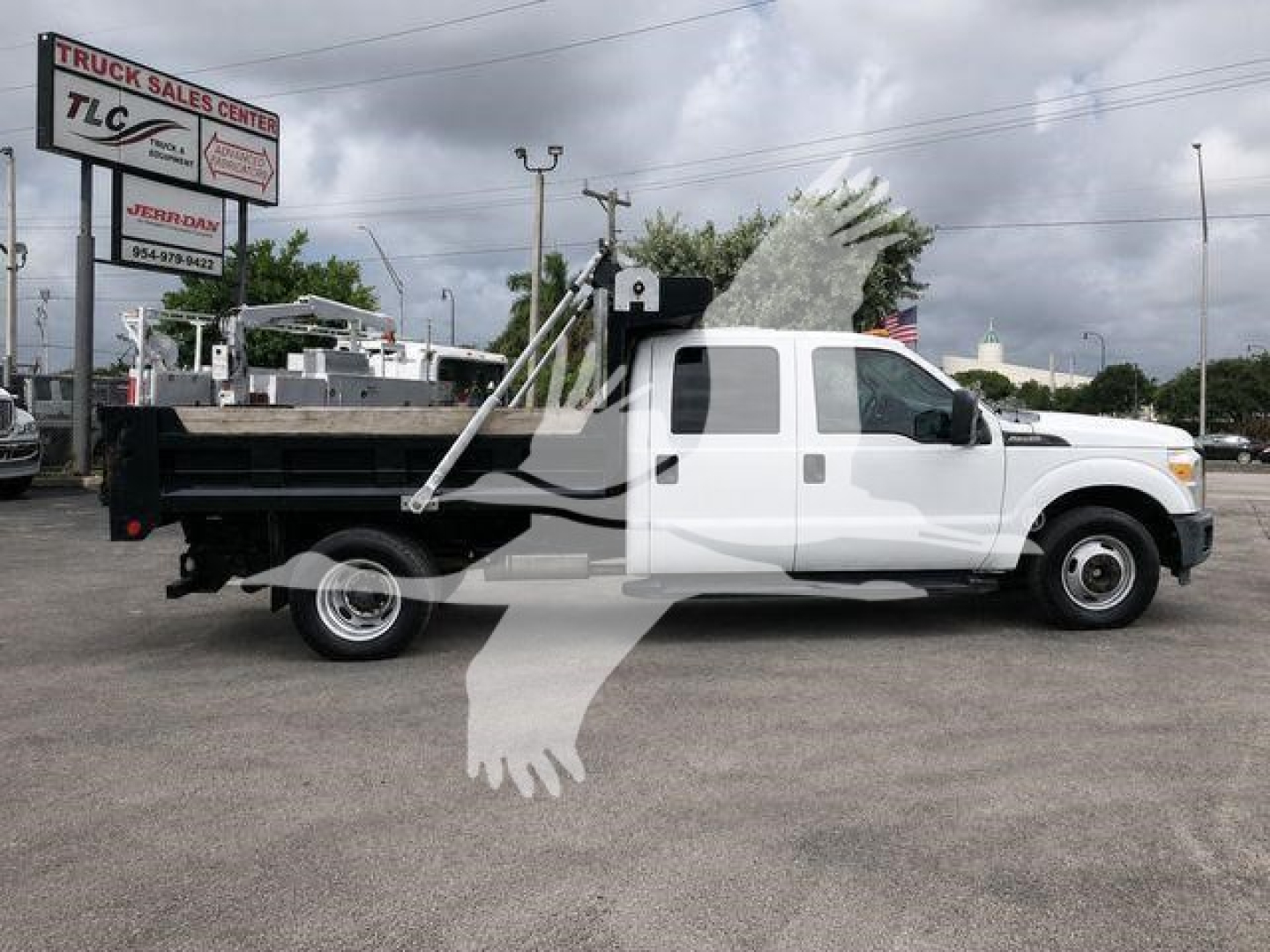 Ford F-350 dumped truck in white with dump bed and hydraulic hoist visible, side view.
