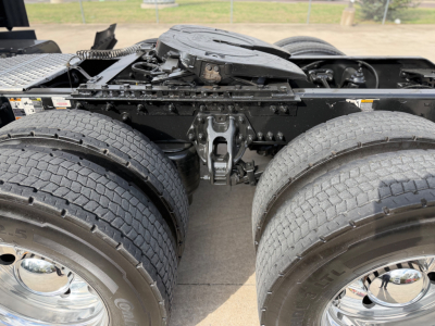 Kenworth T680 chassis view showing dual rear tractor axles and fifth wheel mounting, with visible tires and frame; no text legible other than VIN/stock in description.