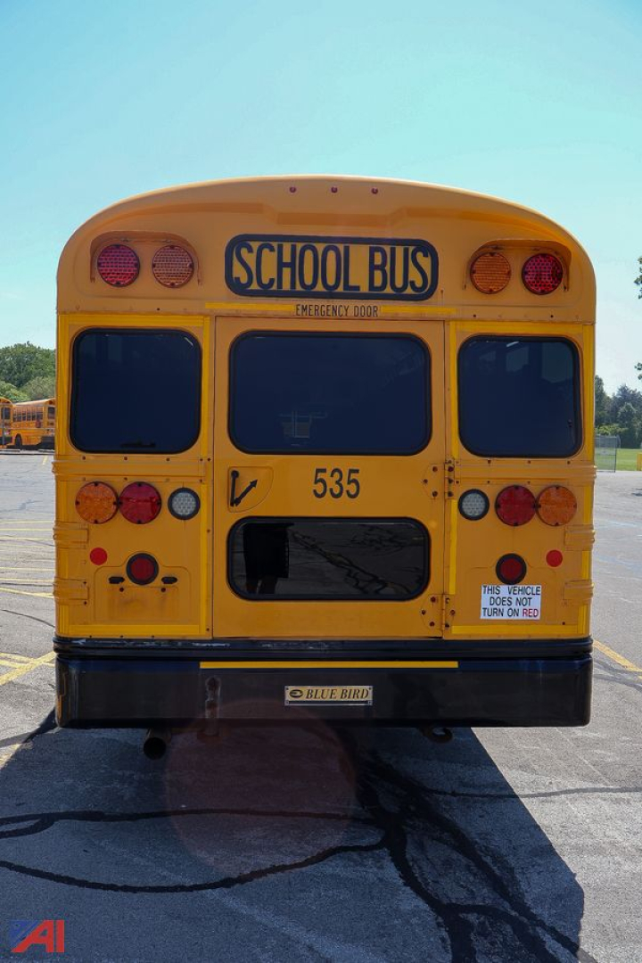 Rear view of a yellow 2018 Blue Bird Vision school bus showing emergency door, lights, and bus number 535.