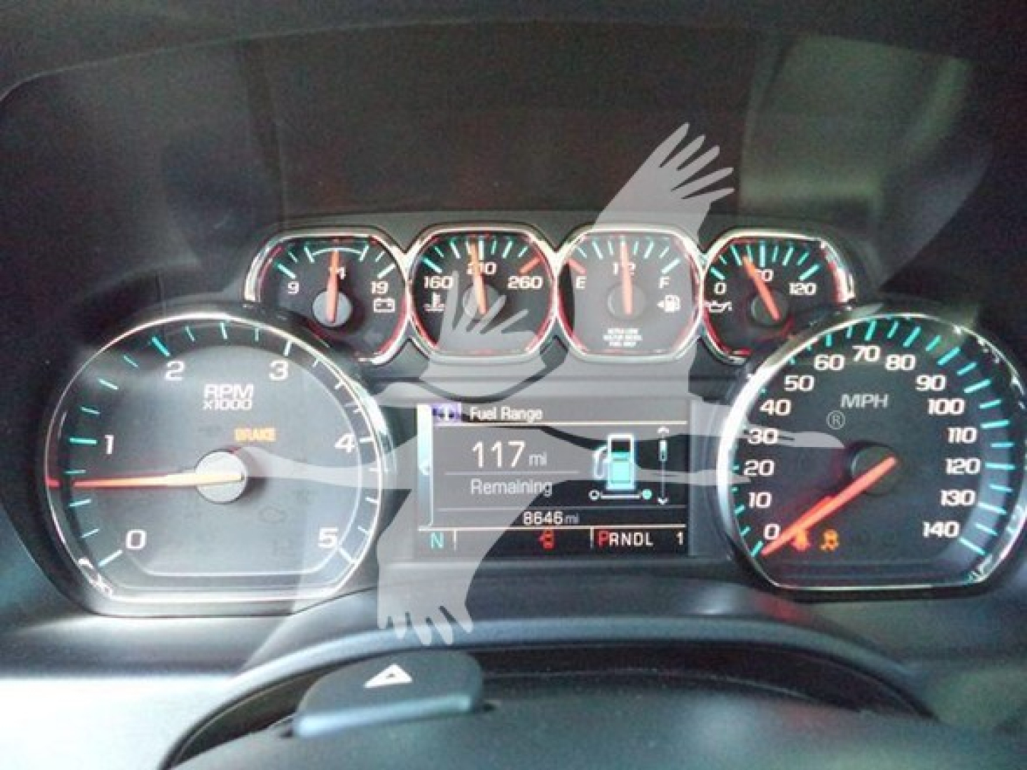 Dashboard view of a 2023 Chevrolet Silverado 6500HD showing analog gauges and digital info center with fuel range 117 miles remaining.