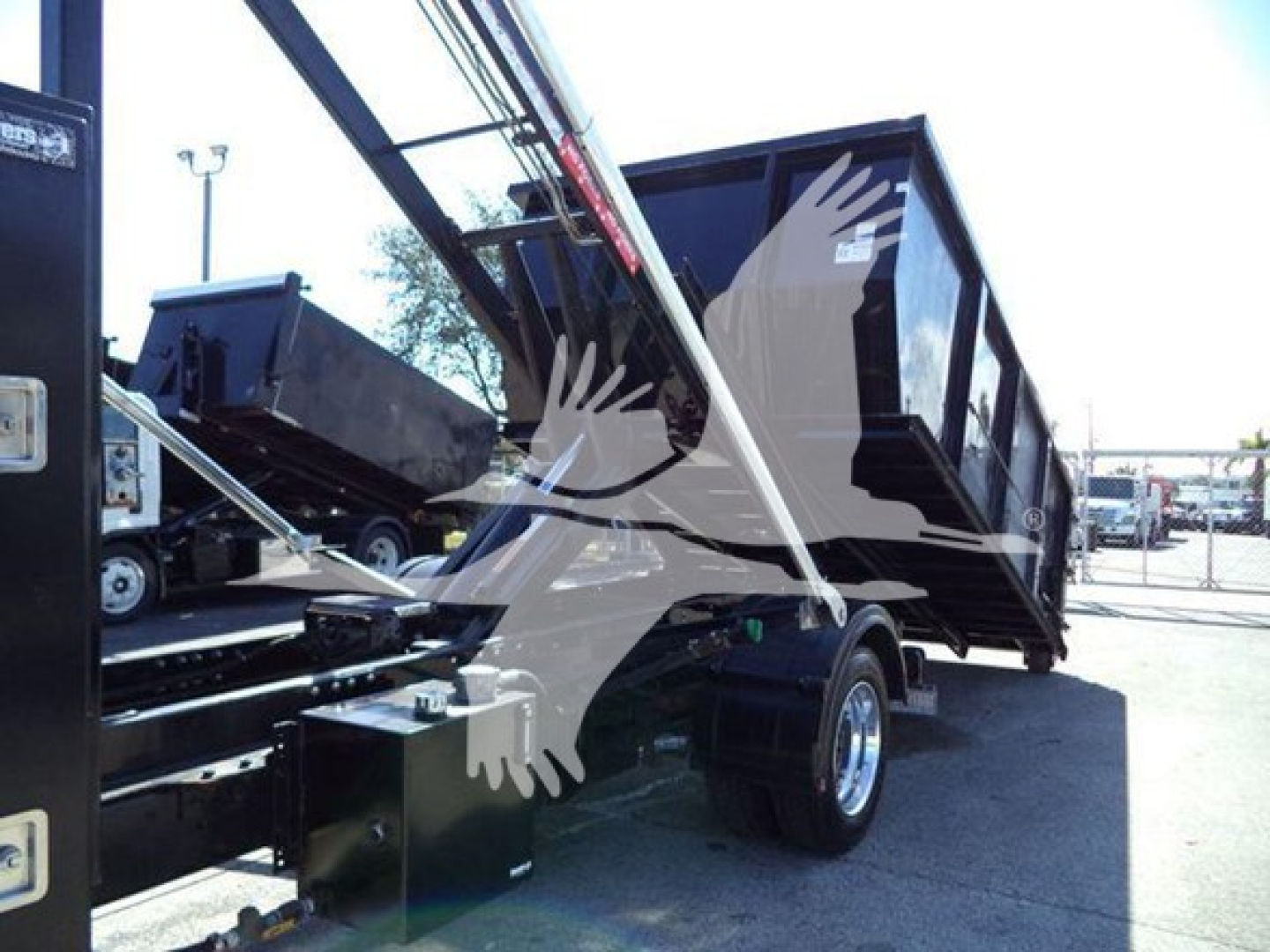 Truck bed with hydraulic hoist and raised dump bed on a Silverado 6500HD dump truck, partial side view and cargo area.
