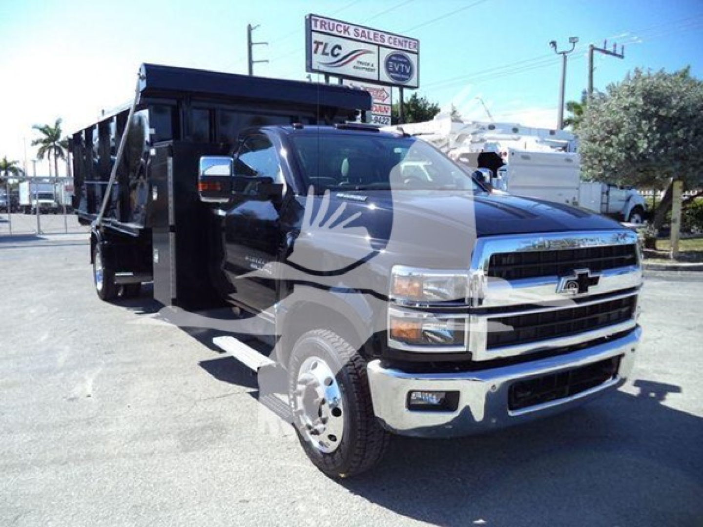 Truck showing a Chevrolet Silverado 6500HD dump body in a side-front view. Visible text includes Chevrolet emblem on grille and stock/VIN details not legible on the image.