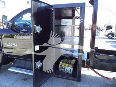 Chevrolet Silverado 6500HD roll-off truck compartment open showing battery and storage shelves