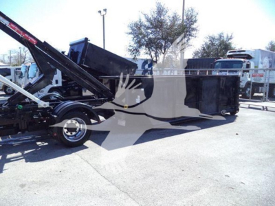 Dump truck with hydraulic roll-off bed and crane arm showing side panels and rear wheels.
