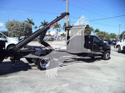 Truck with a crane/telescoping arm and flatbed, side view showing the cab and dashboard area. Visible markings not clear, no legible labels readable.