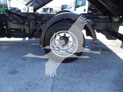 Military gray wheel and tire assembly of a heavy-duty Chevrolet Silverado 6500HD chassis showing spare wheel and surrounding frame components.