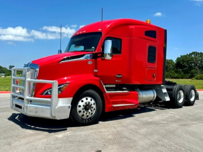 Kenworth T680 tractor in red, side view showing front grille guard and sleeper cab.