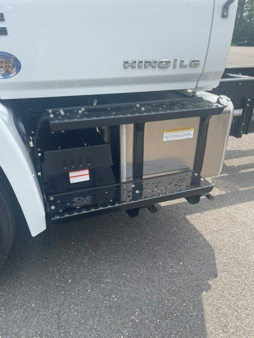 Cab chassis truck side showing under-seat storage and fuel/air tanks with Hino logo on the cab door.
