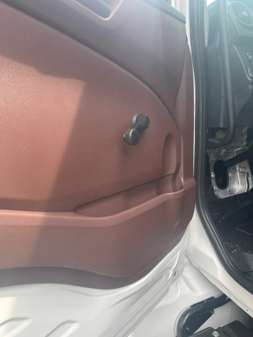 Cab door interior of a 2027 Hino L6 showing manual window crank and brown interior panel.