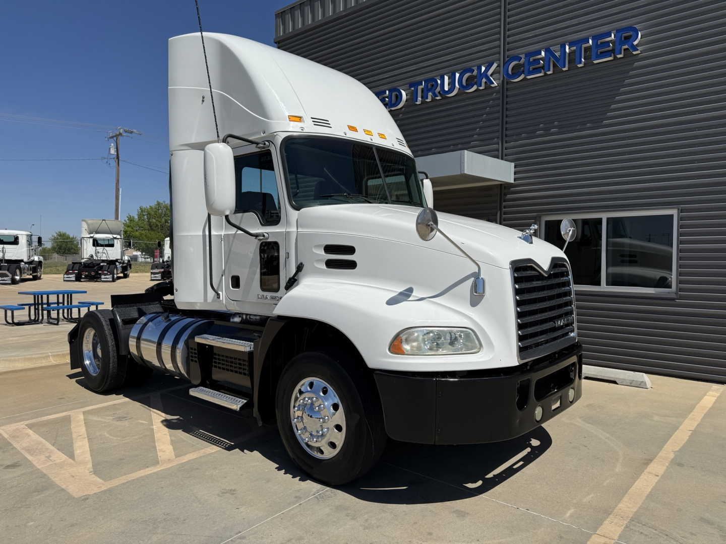 Truck cab with white exterior and dual fuel tanks showing Mack CXU612 daycab VIN 1M1AW06YXJM011081 stock B3026P